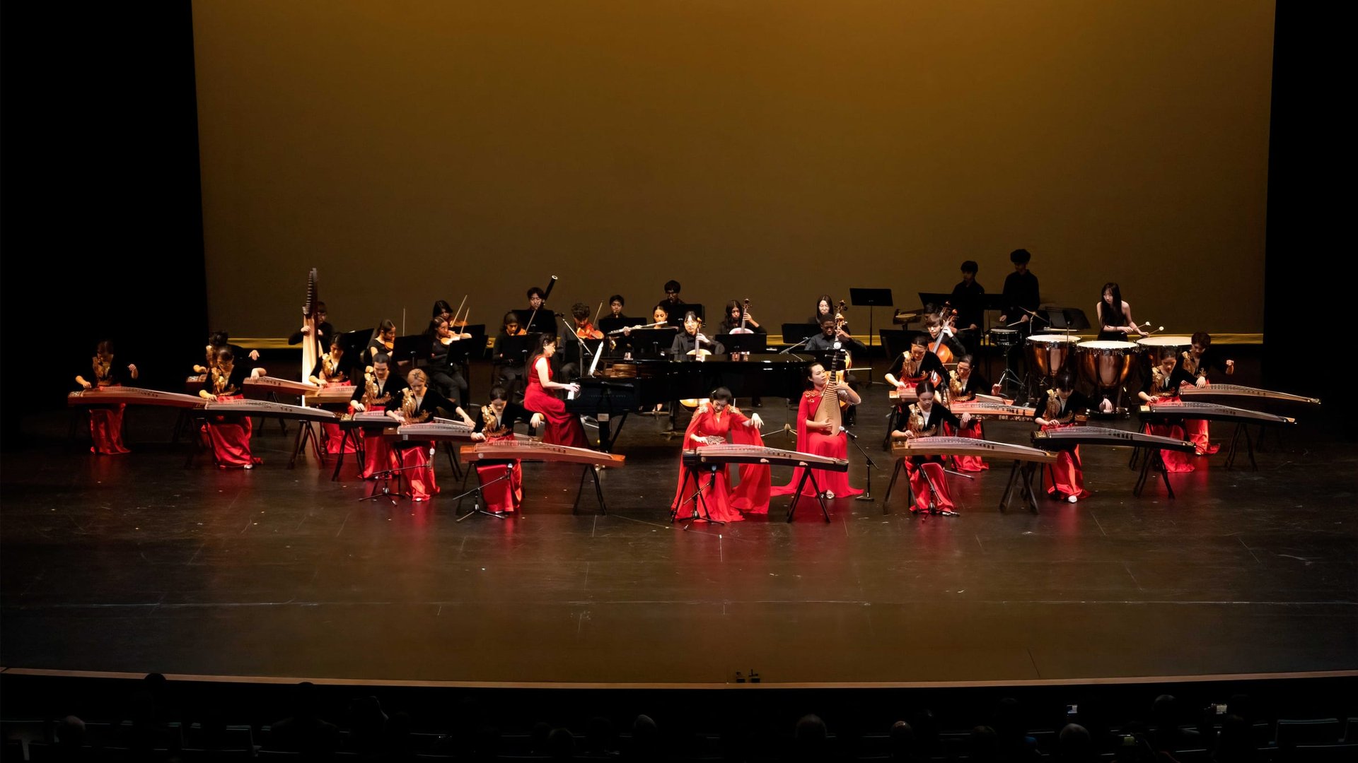 Guzheng musicians and orchestra performing on stage at Music of Love 2026